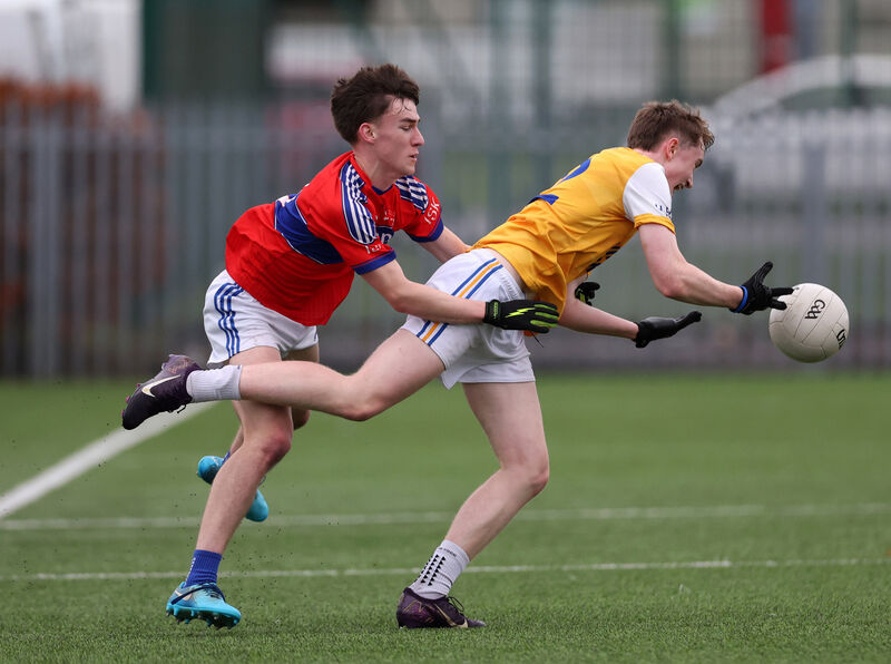  Adam Griffin, Hamilton High School, gets his pass away under pressure from Eanna Murphy, IS Killorglin. Picture: Jim Coughlan.