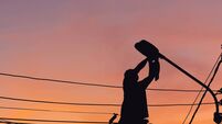 Silhouette of Electrician checking lighting to the LED street lamp post, Technician with clipping path and maintenance service c