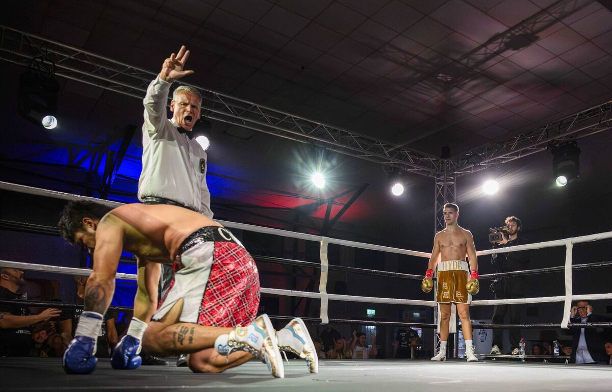 Cork's Tommy Hyde watches on as Paul Valenzuela Jnr of Mexico is counted out by referee Peter Unbennant to end their bout during the Nowhere2Hyde Revolution pro boxing show held at the Parochial Hall, Cork