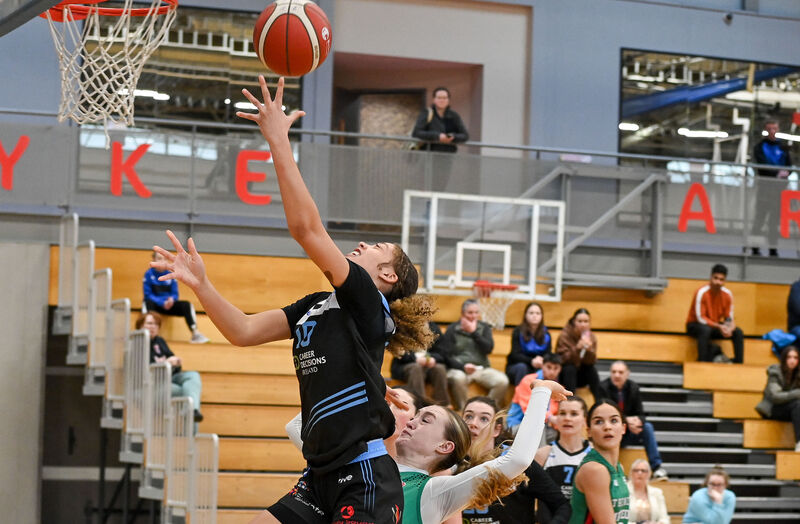  UCC Glanmire's Jewel Watkins scores under pressure from Trinity Meteors' Ava Learn. Picture: David Keane.