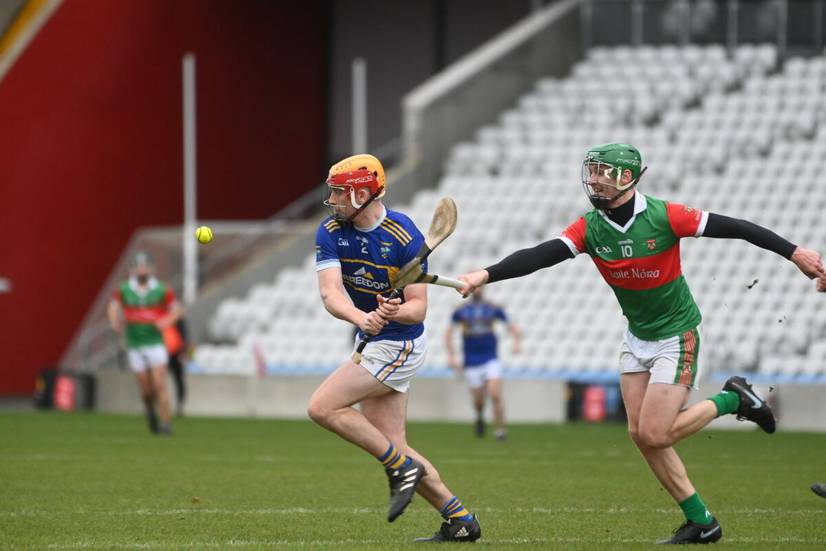  David Guiney, Kilshannig clears the danger against Darragh Corkery, Ballinora. Picture: Larry Cummins