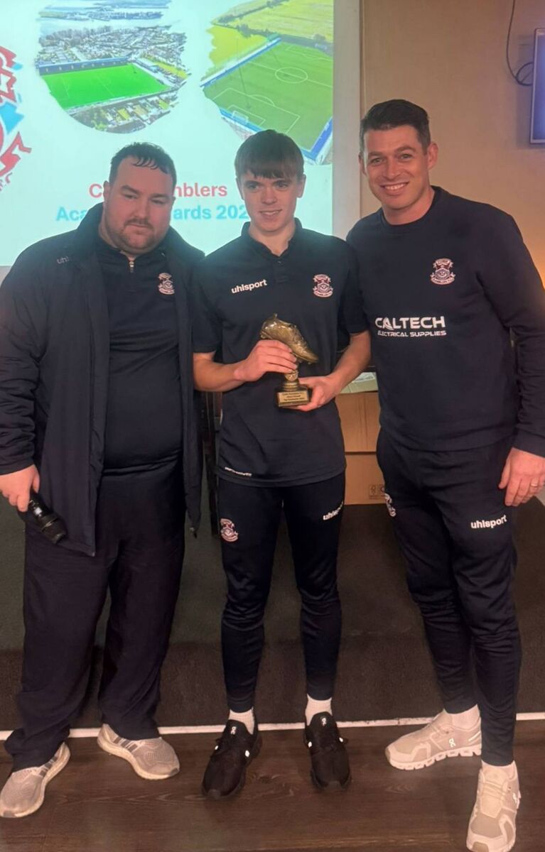 Alan Geasley and Conor Meade present Ethan O’Donoavn with Cobh Ramblers' U15 Player of the Year.