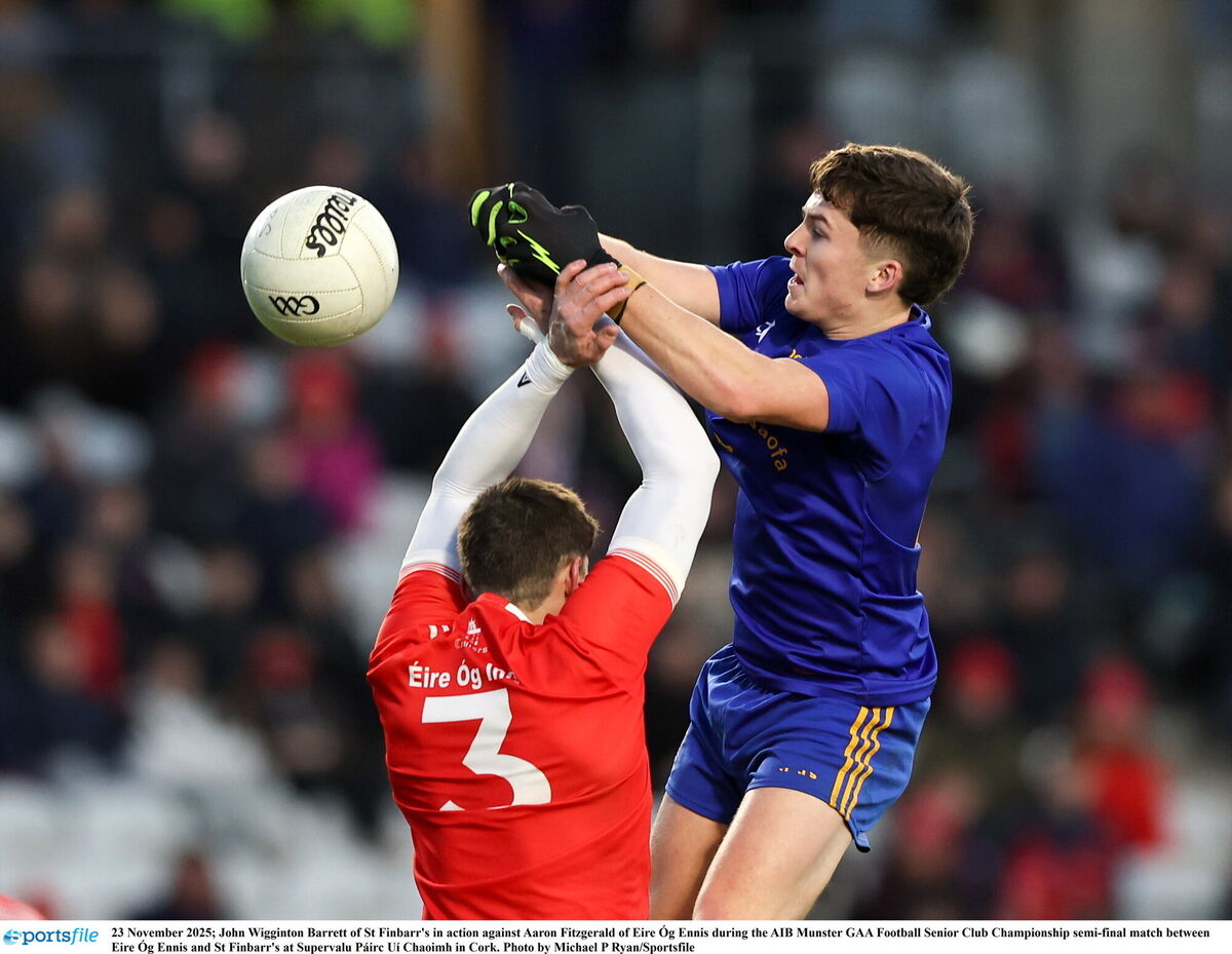 John Wigginton-Barrett of St Finbarr's in action against Aaron Fitzgerald of Éire Óg of Ennis. Picture: Michael P Ryan/Sportsfile