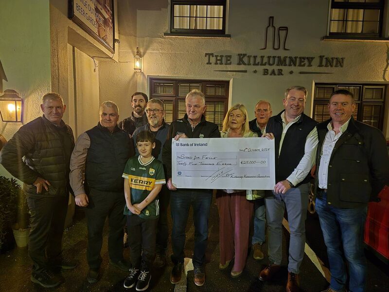 Stand for Féile fundraiser that was held at the Killumney Inn recently. John Crean presents the cheque to John O'Connor. 