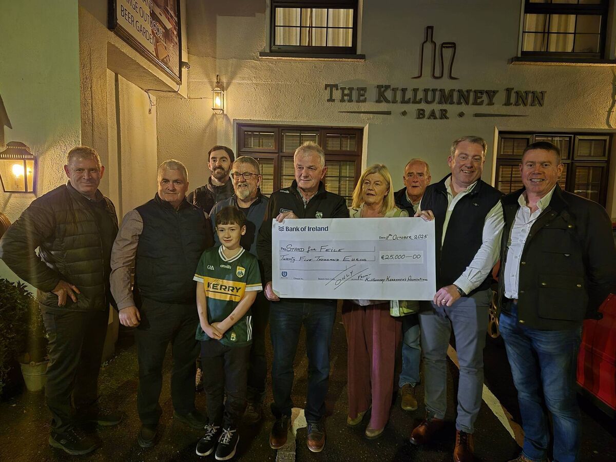 Stand for Féile fundraiser that was held at the Killumney Inn recently. John Crean presents the cheque to John O'Connor. 