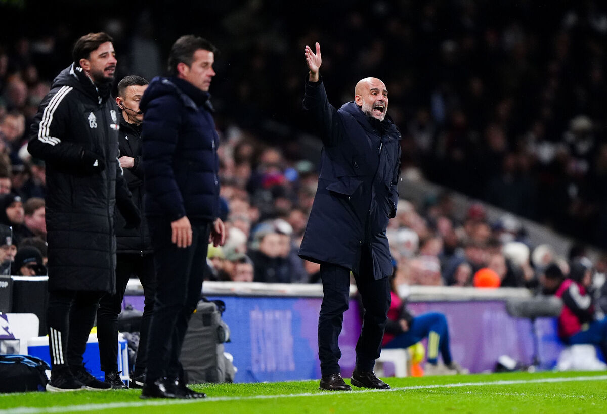 Manchester City manager Pep Guardiola during the Premier League match at Craven Cottage, London, while Fulham boss Marco Silva looks on. Picture: Bradley Collyer/PA Wire