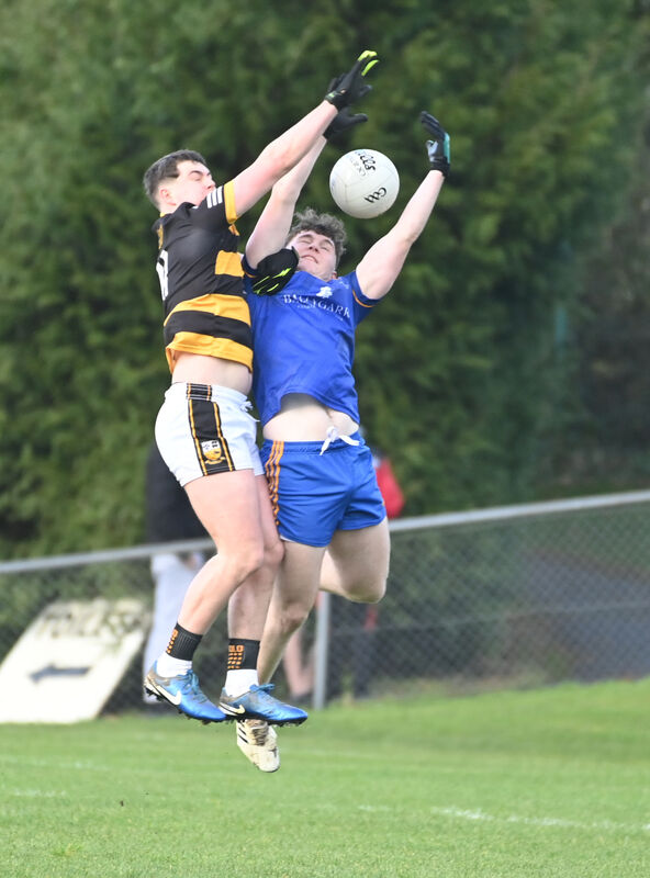 Buttevant's Conor Hanlon goes high with Ballymacelligott's Eoin Moriarty. Picture: Eddie O'Hare Buttevant's Conor Hanlon goes high with Ballymacelligott's Eoin Moriarty. Picture: Eddie O'Hare