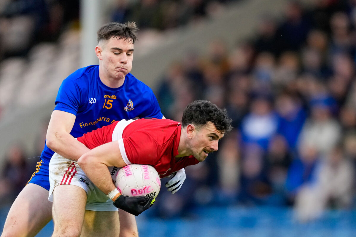 Mark O'Connor of Dingle is tackled by Rickey Barrett of St Finbarr's. Picture: INPHO/James Lawlor