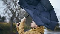 Man with umbrella in wind and rain