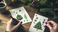 Eco-friendly plantable Christmas cards displayed on a wooden table during the holiday season, featuring holiday designs