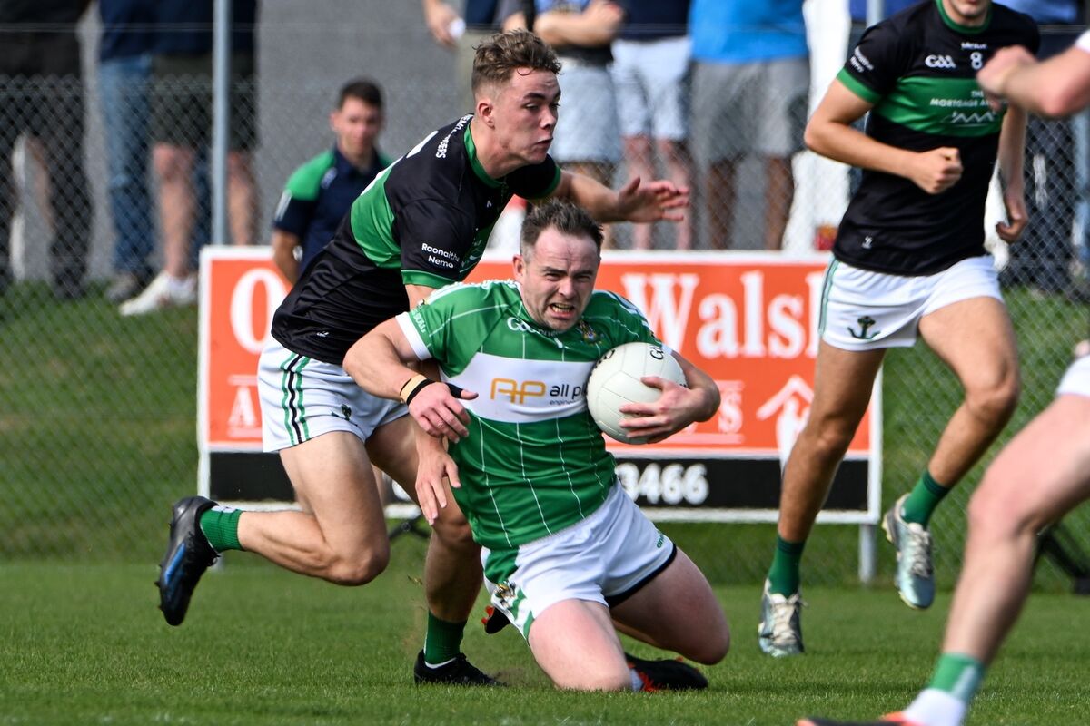 Aghabullogue captain John Corkery is brought to his knees by a strong challenge from Nemo Rangers' Conor Moore this year. Picture: Chani Anderson