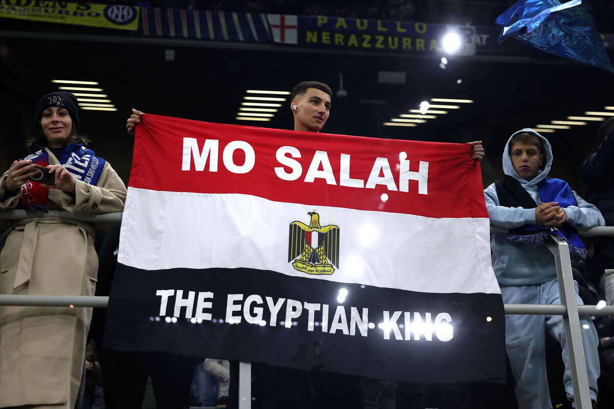 A fan holds a flag with the name of Liverpool player Mohamed Salah during the UEFA Champions League match at the San Siro in Milan, Italy. Picture: Fabrizio Carabelli/PA Wire