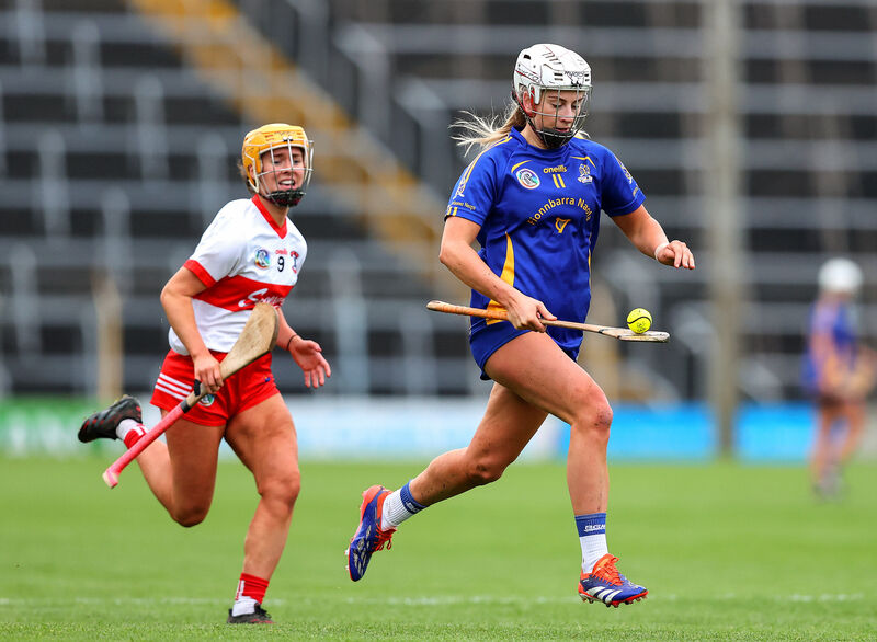 St Finbarr's Kate Wall breaks away from De La Salle's Leah Browne during the AIB Munster Club Senior Camogie Championship final at FBD Semple Stadium. Picture: INPHO/Tom O'Hanlon