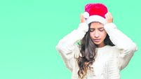 Young arab woman wearing christmas hat over isolated background suffering from headache desperate and stressed because pain and