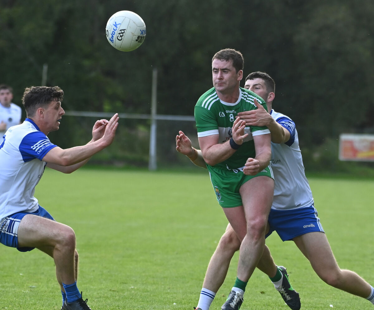 Macroom's Fintan Goold gets off his pass from Knocknagree's Denis R O'Connor and Timmy O'Connor in 2023. Picture: Eddie O'Hare