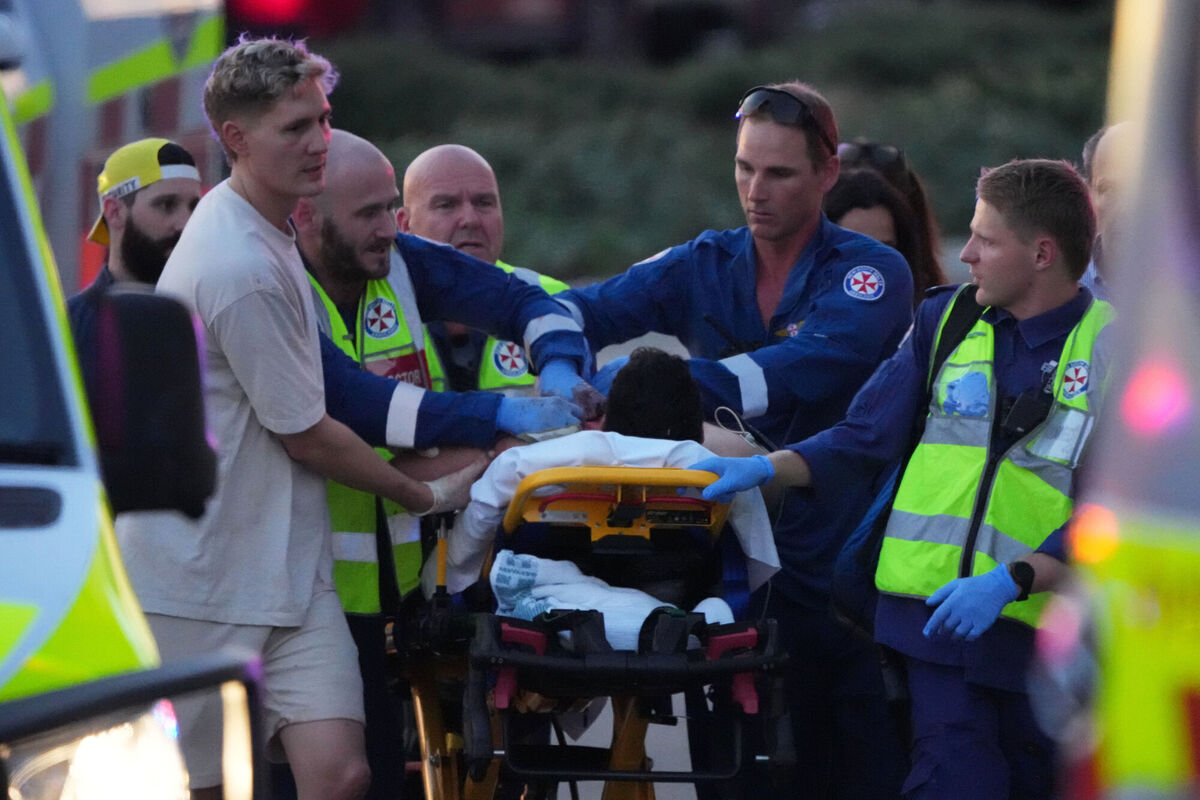 Emergency workers transport a person on a stretcher after a reported shooting at Bondi Beach, in Sydney, Sunday, Dec. 14, 2025. (AP Photo/Mark Baker)