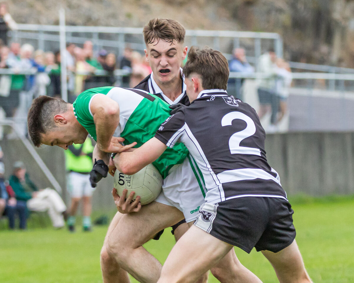Castletownbere's Jack Hanley and Billy Murphy tackle Macroom's Eolan O'Leary this year. Picture: Anne Marie Cronin