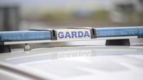 Garda sign and blue lights on a Garda car.