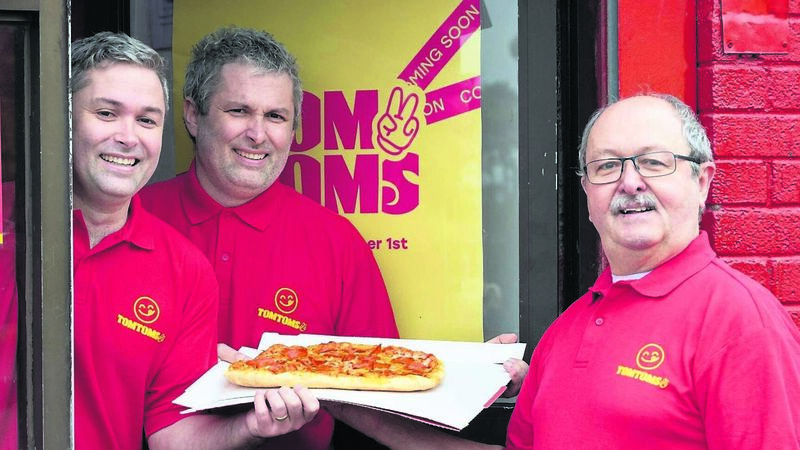 Cork chipper boss Tom hands over a pizza the action to his twins