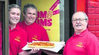 Cork chipper boss Tom hands over a pizza the action to his twins