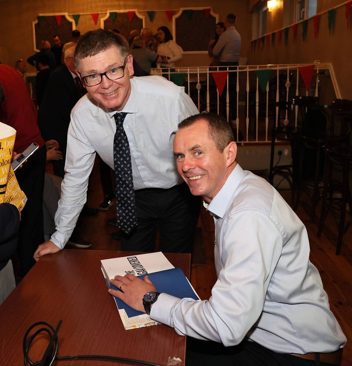 John Kelly, author of The GAA Covered, signs a copy for GAA Director General Tom Ryan.