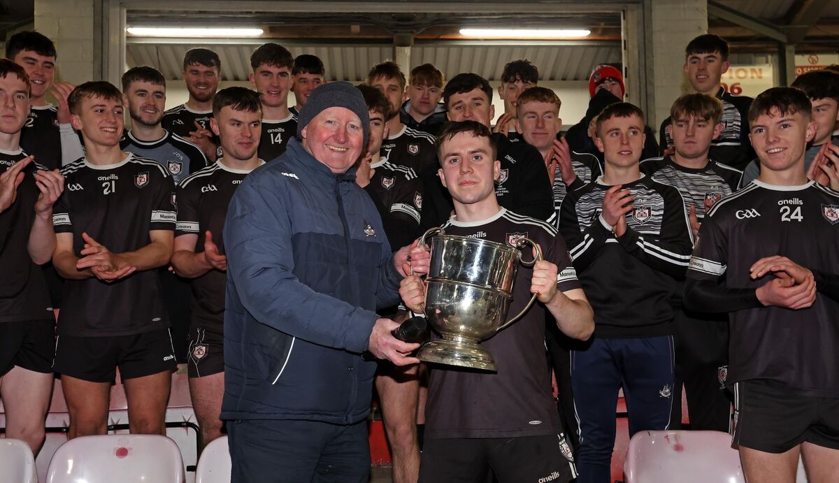 Midleton U21 captain Alex Quirke receives the Dick Barrett Cup from Cork County Board chairperson Pat Horgan after last year's county final win over St Finbarr's at Páirc Uí Rinn. Picture: Jim Coughlan