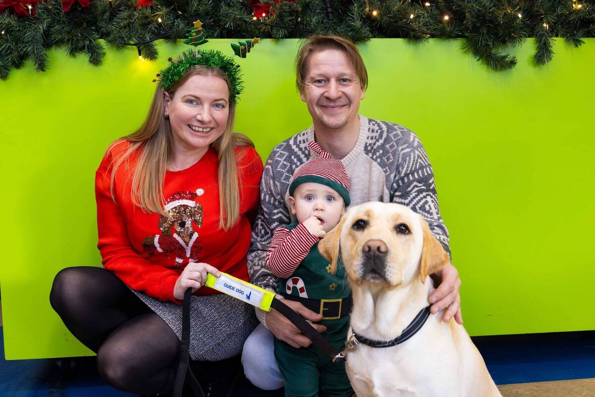 Emma, Sam and Peter Medo, pictured with service dog, Dolly, as a team of volunteers from Apple Cork spent the day at the Irish Guide Dogs for the Blind HQ on Model Farm Road, helping with preparations for Christmas activities, meeting families and helping Santa and his elves in the grotto.	Picture: Michael O’Sullivan / OSM PHOTO
                    
