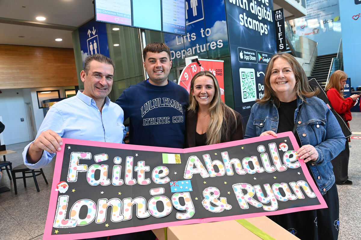  Troy Murphy, Glanmire with his son Ryan, and Lonnóg Ní Mhaoláin and her mum Niamh, from Douglas at Cork Airport as the couple return from Sydney, Australia for Christmas in Cork. Picture: Larry Cummins