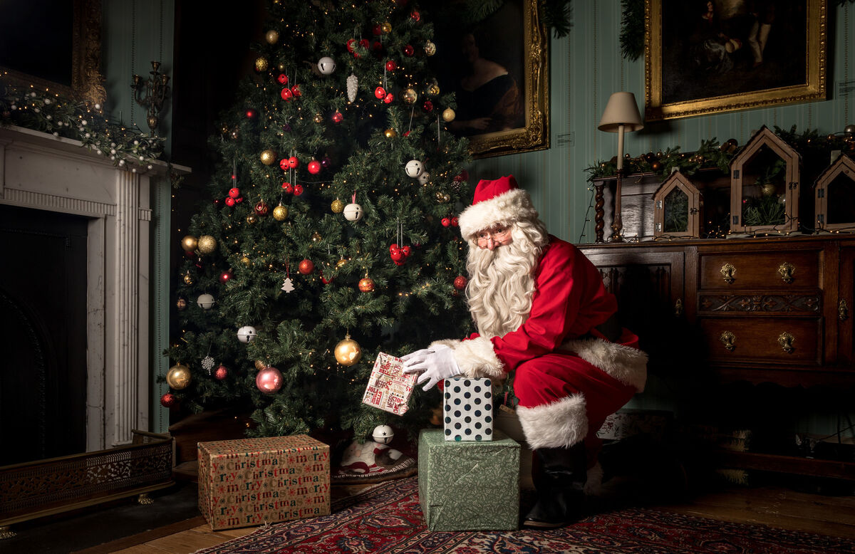 Pat Bransfield as Santa placing presents under the tree in Fota House, Co. Cork. Picture: David Creedon