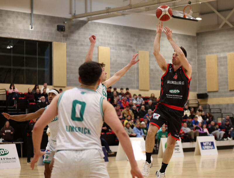  Adrian O'Sullivan, Ballincollig, shooting over Finn Hughes, Limerick Celtics. Picture: Jim Coughlan.