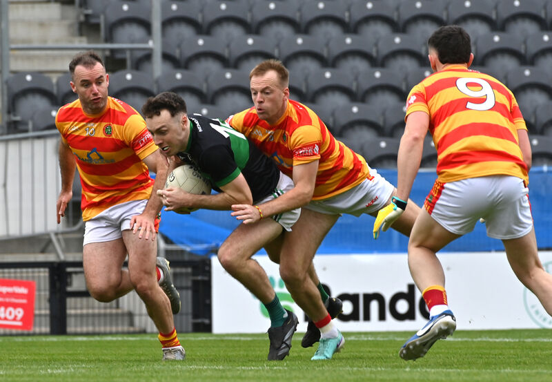  Barry Cripps, Nemo Rangers is tackled by Luke Meade, Newcestown, one of three 2025 winners for the Carbery club. Picture: Dan Linehan