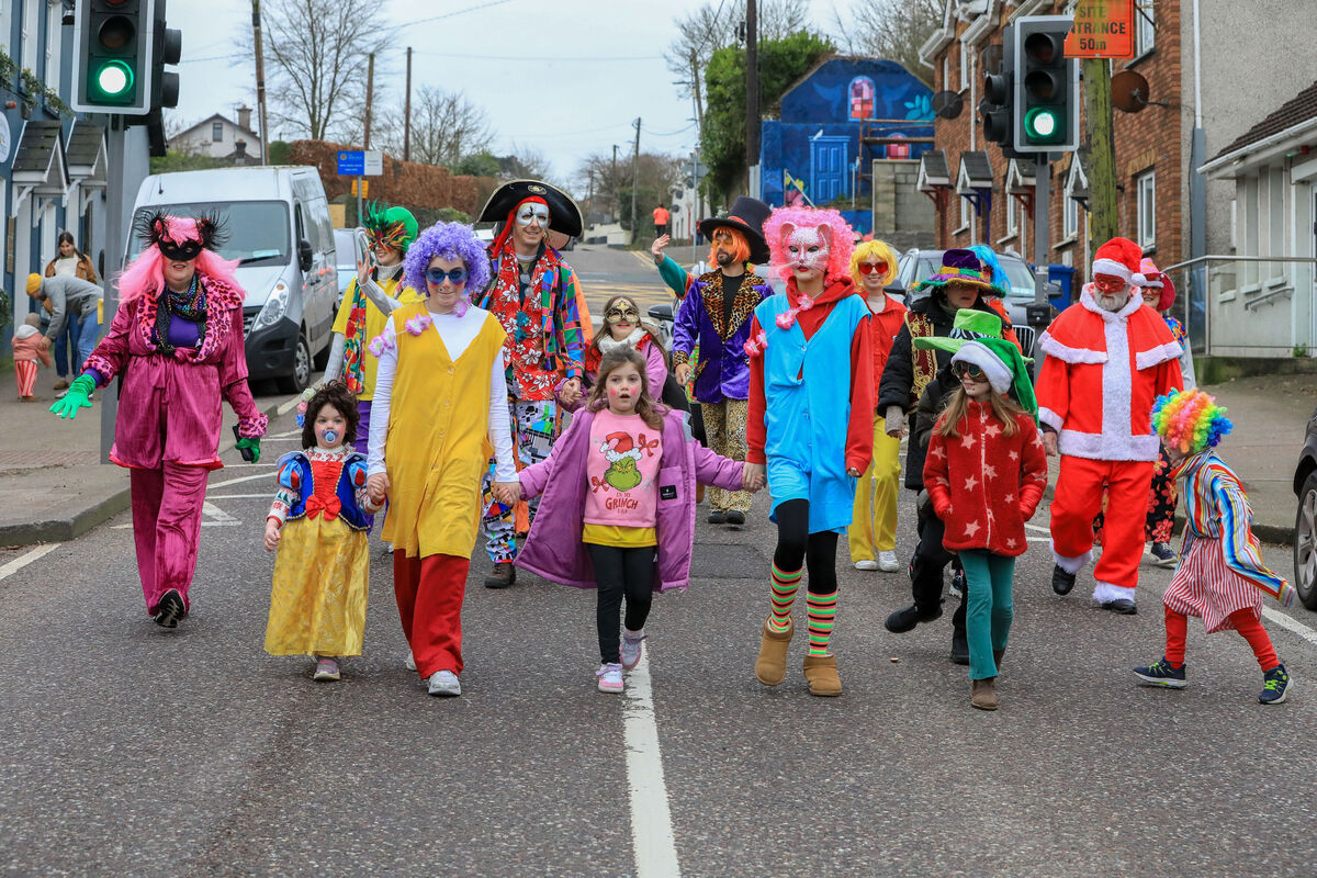The colourful wren boys arrive down Main Street to take part at the Street Festival that was held on St. Stephen's day in Carrigaline, Co. Cork.