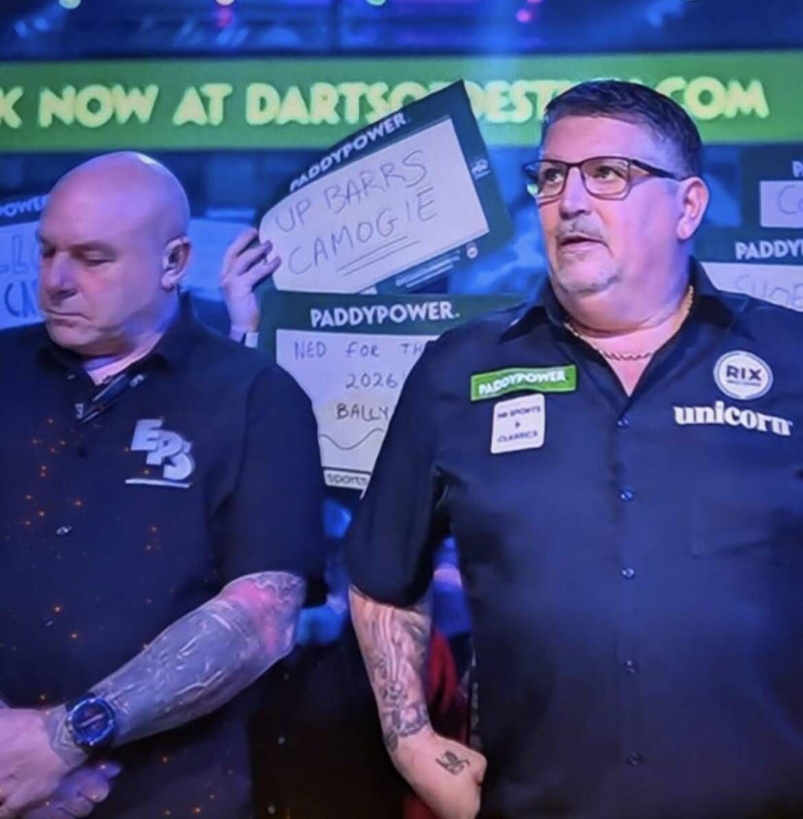 A St Finbarr's camogie team supporter holds a sign up to show their support for the side ahead of the AIB All-Ireland club championship final replay on Saturday during the world championship darts game between Jermaine Wattimena and Gary Anderson at the Alexandra Palace in London.