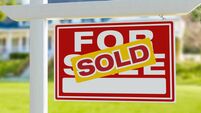 Sold For Sale Real Estate Sign in Front of New House.