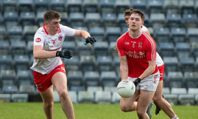 Ballygarvan's Seán Brady about to hand pass the ball as Castlemartyr's Darragh Joyce closes in. Picture: Howard Crowdy