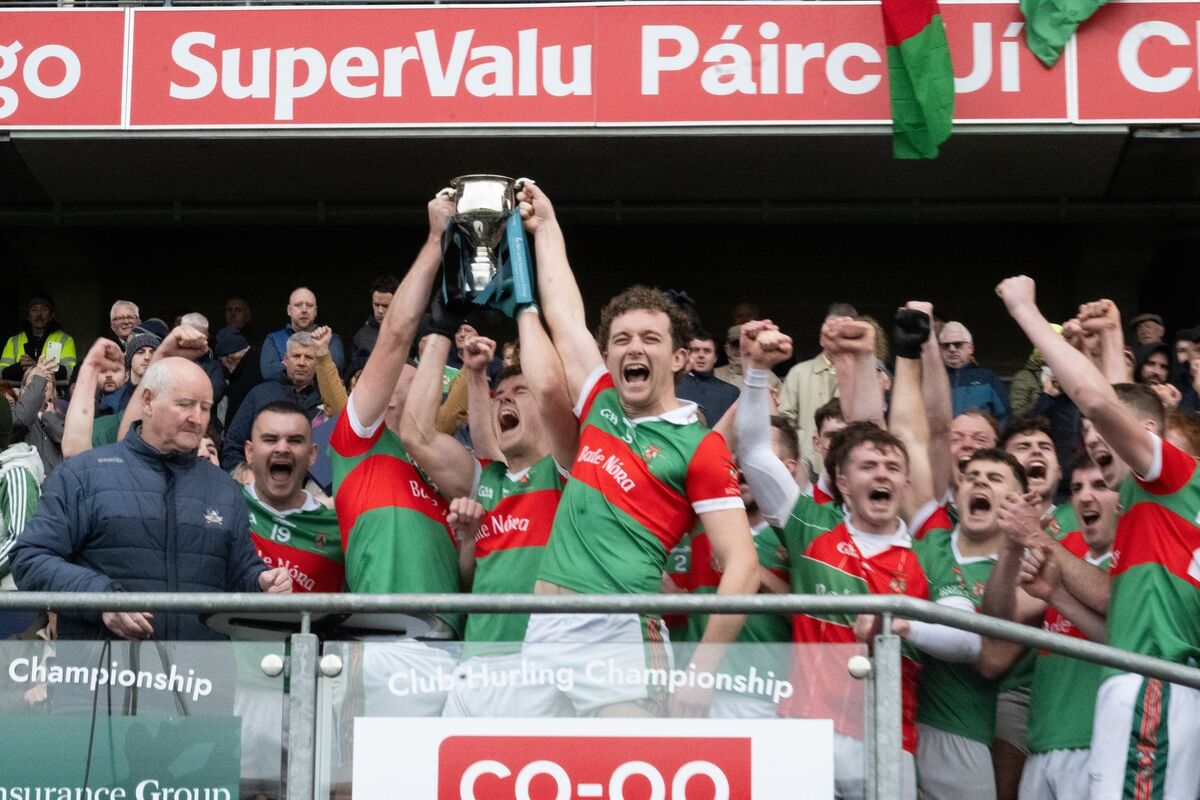 The Lordan brothers, Mike, James and Neil, lift the trophy after Ballinora defeated Ilen Rovers. Picture: Chani Anderson