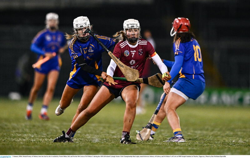Sinéad Feeney of Athenry loses her hurl as she is tackled by Nicole Olden and Sorcha McCartan of St Finbarr’s. Picture: Ben McShane/Sportsfile