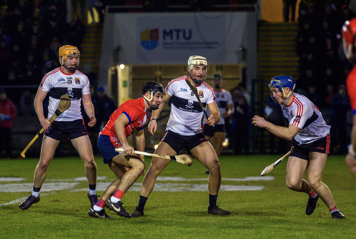  UCC players Darragh Flynn, Brian Keating and Eddie Stokes closing in on Mikey Finn of MTU Cork. Picture: Dan Linehan