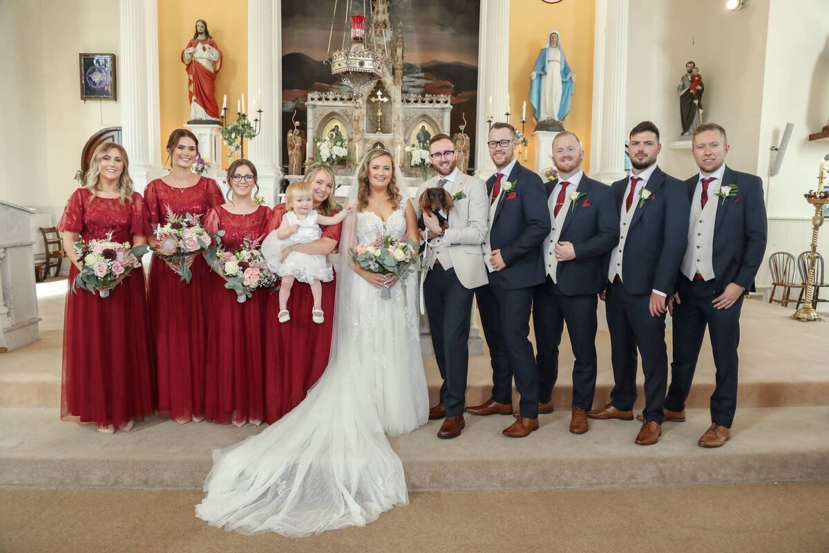 The couple pictured with bridesmaids, Tara Murphy, Mira Brady, Martina Moloney, and Rebecca Farr, best man Mark Sheehan, and groomsmen Jack O’Shea, Rob Collins and Denis O’Connell. Megan’s niece Róise Hyde was flowergirl.