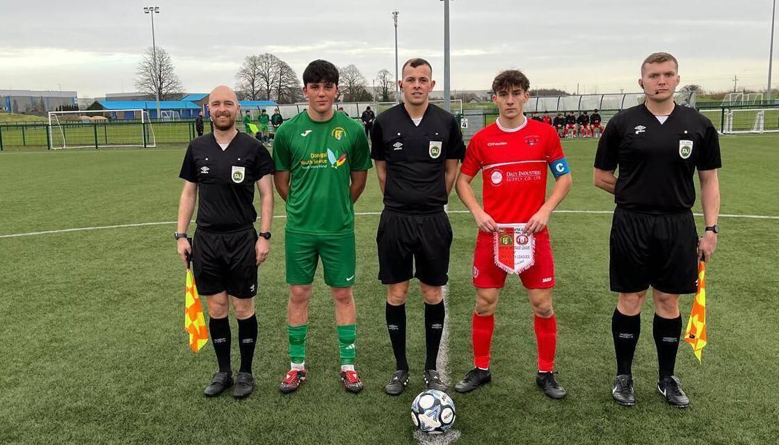 Assistant referee Jamie Purcell, Donegal Youth League captain Harry Doherty, referee Paul Farrell, Cork Youth League captain Mathew Kiernan and assistant referee Eoin Fagan.