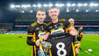 Eoin O'Neill and Aaron Holland celebrates while holding up no8 jersey of a player who passed away this year 10/1/2026