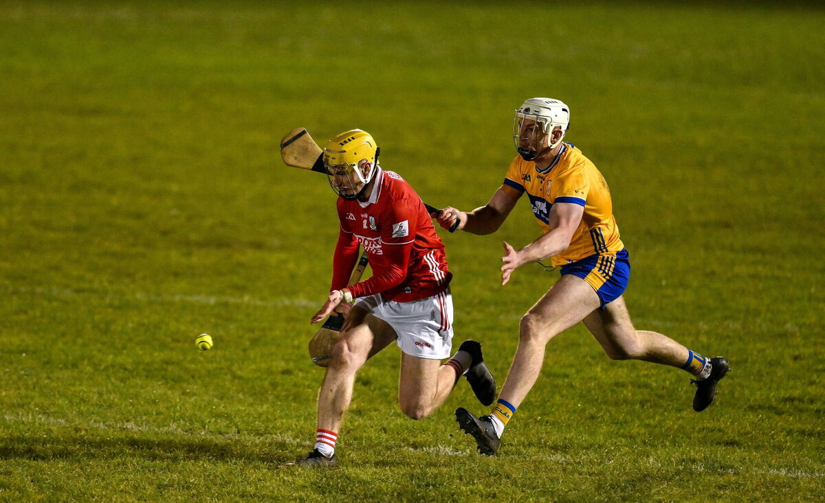 Seán Desmond of Cork gathers possession ahead of Conor Cleary of Clare. Photo by Brendan Moran/Sportsilfe