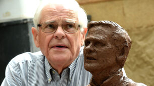 <p>Seán Ó Sé looks over the ceramic bust of himself, created by sculptor Sean MacCarthy at the National Sculpture Factory, Cork in 2017. File picture: Larry Cummins</p>