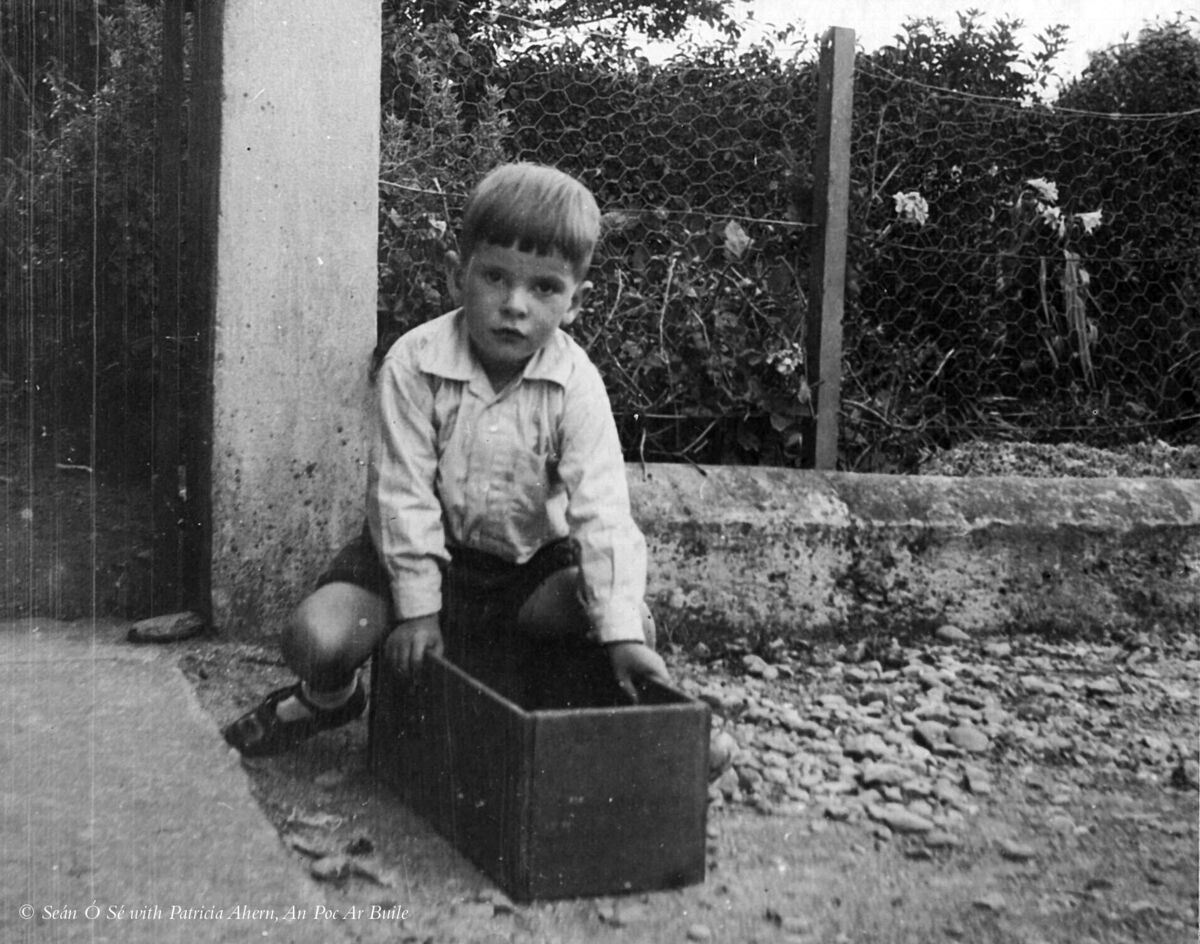 Seán, aged around six, at his father’s former home in Adrigole, west Cork, with his favourite toy – with a bit of imagination, it could be anything. taken from An Poc Ar Buile – The Life &amp; Times of Seán Ó Sé by Seán Ó Sé with Patricia Ahern, published by The Collins Press, 2015