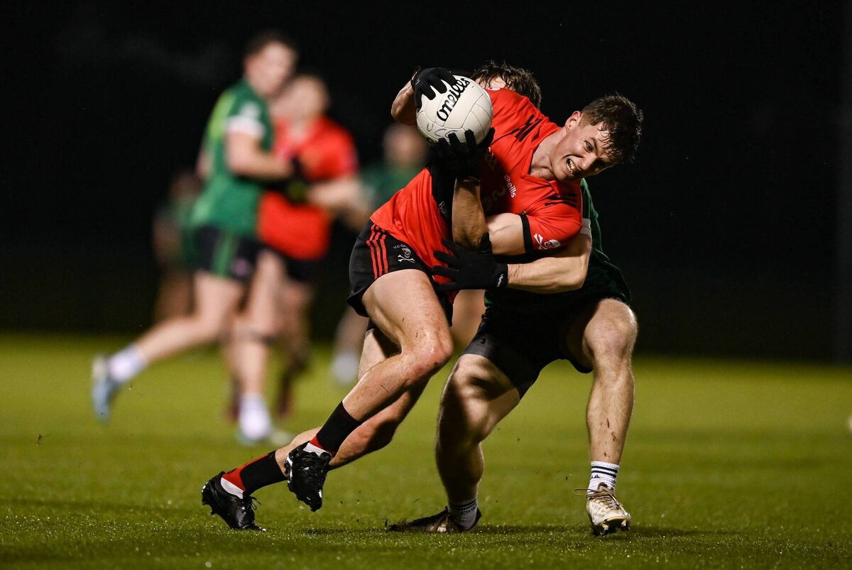 Dan Peet of UCC in action against Ryan McQuillan of Queen's University Belfast. Picture: Tyler Miller/Sportsfile