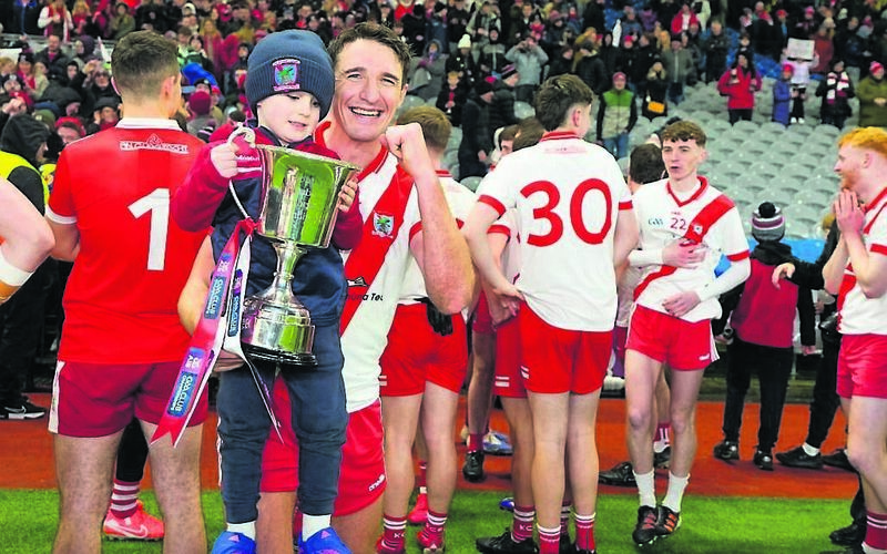Aodán Breathnach of An Ghaeltacht and his son Macdara celebrate after An Ghaeltacht won the