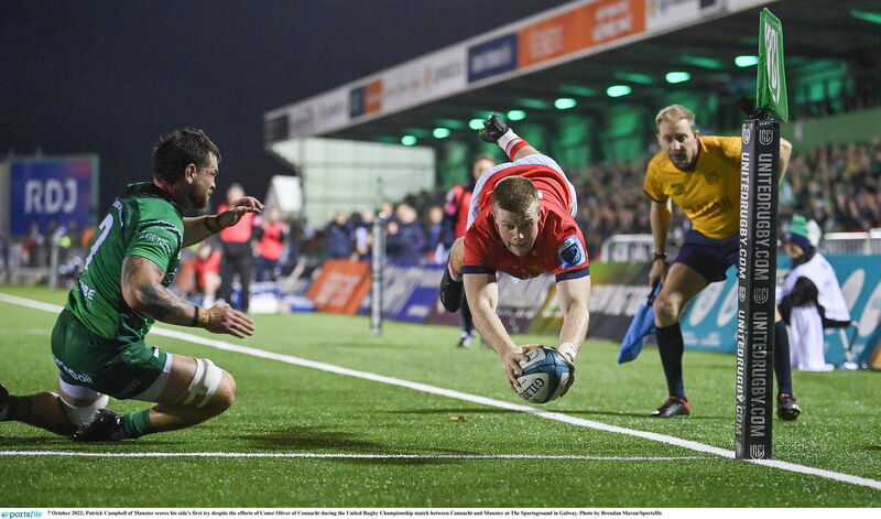 Patrick Campbell of Munster scores his side's first try despite the efforts of Conor Oliver of Connacht in 2022. Picture: Brendan Moran/Sportsfile