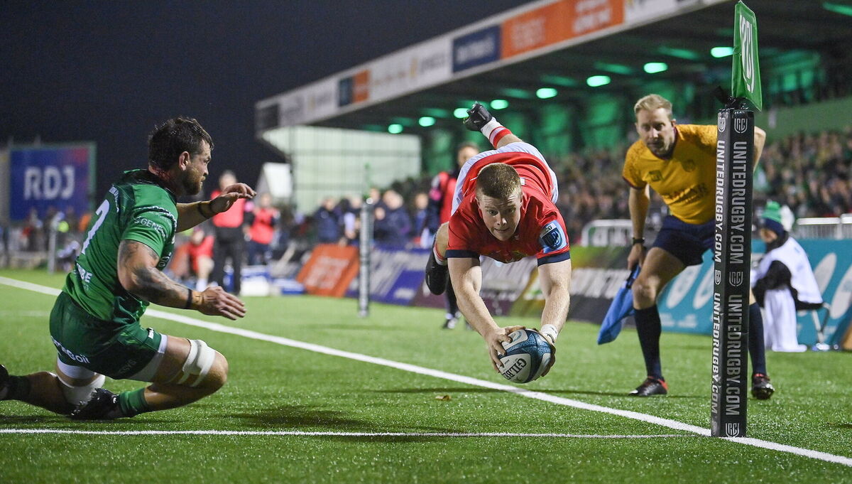 Patrick Campbell of Munster scores his side's first try despite the efforts of Conor Oliver of Connacht in 2022. Picture: Brendan Moran/Sportsfile