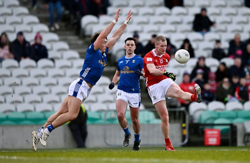 Ruairí Deane of Cork kicks a point despite the attention of Conor Brady of Cavan. Picture: Ben McShane/Sportsfile Ruairí Deane of Cork kicks a point despite the attention of Conor Brady of Cavan. Picture: Ben McShane/Sportsfile