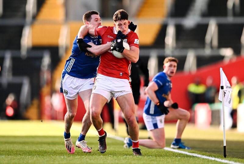 Colm O'Callaghan of Cork is tackled by Ciaran Brady of Cavan. Picture: Ben McShane/Sportsfile